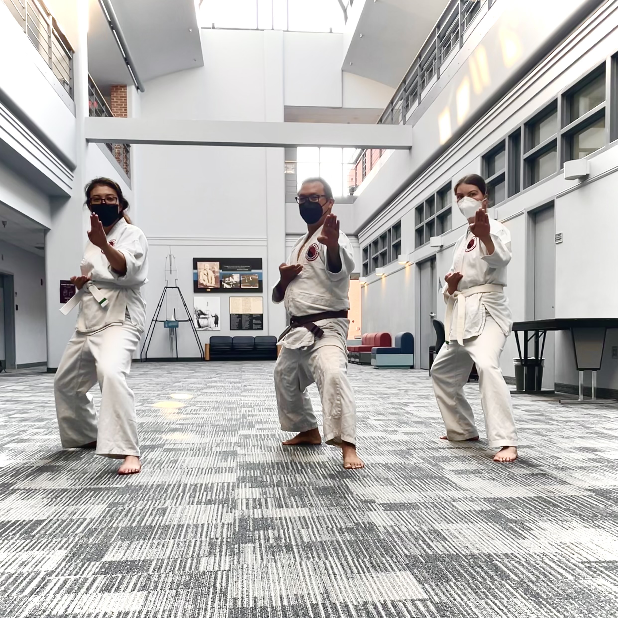 From left to right: Stela Ishitani, Alex Nguyen, and Emily Beckman, demonstrating a back stance